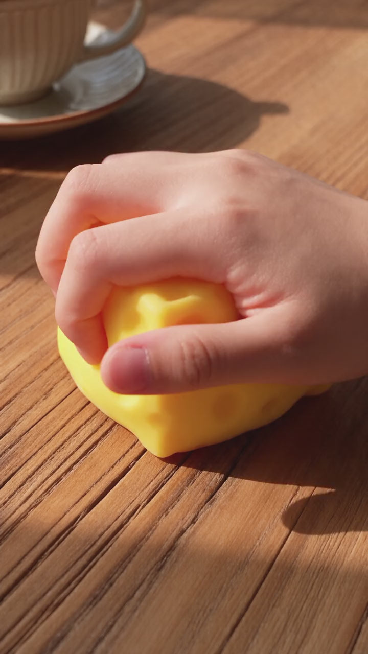Squeezing the SquishJoy Cheese Block and watching it slowly rise